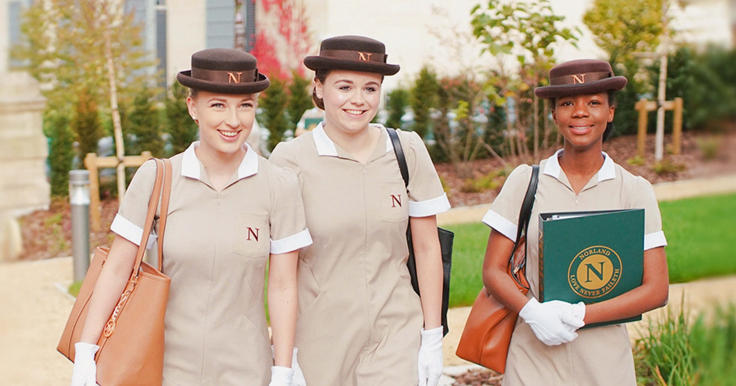 Photograph of three Norland Students walking and smiling.